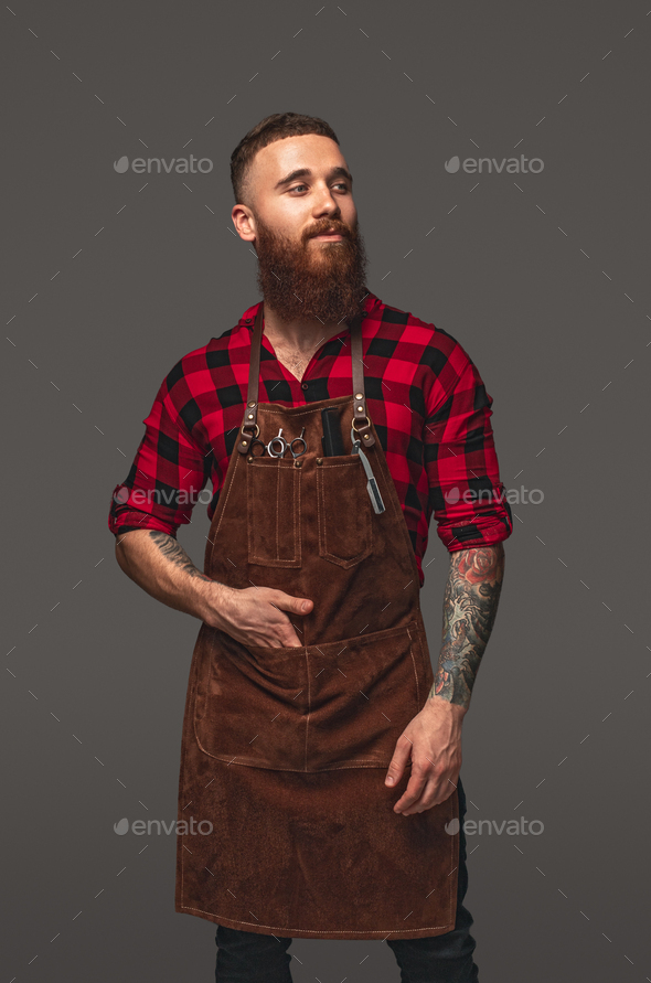 Confident barber with hand in pocket