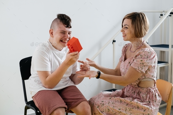 Therapist doing development activities with cerebral palsy boy