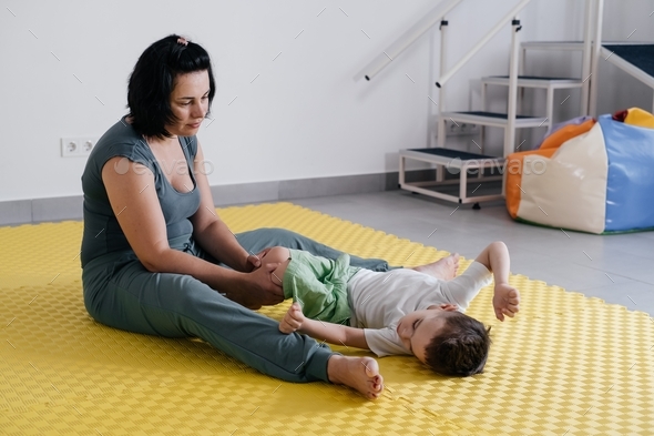therapist doing rehabilitation of children with cerebral palsy