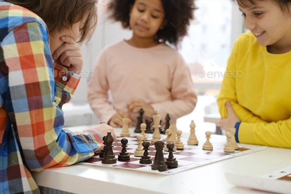 multiethnic kids playing chess board game at school Stock Photo by ...