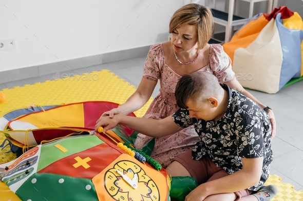 disabled child doing sensory activity with toys, rehabilitation