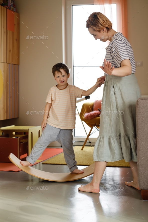 Child playing on balance Board for Toddlers in kids room