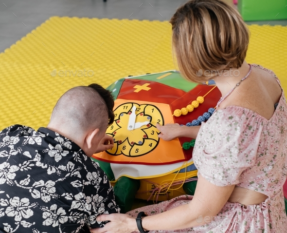 disabled child doing sensory activity with toys, rehabilitation