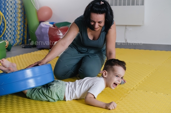 therapist doing rehabilitation of children with cerebral palsy
