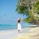 Girl in a white dress walking on a tropical beach - PhotoDune Item for Sale