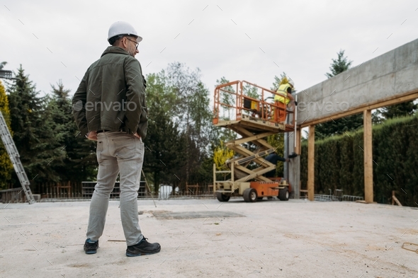 Scissor Lift Platform on a construction site near the wall