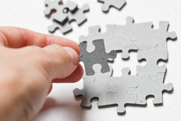 Photo Of A Hand Of A Woman Or Girl Putting Puzzle Pieces Together On ...