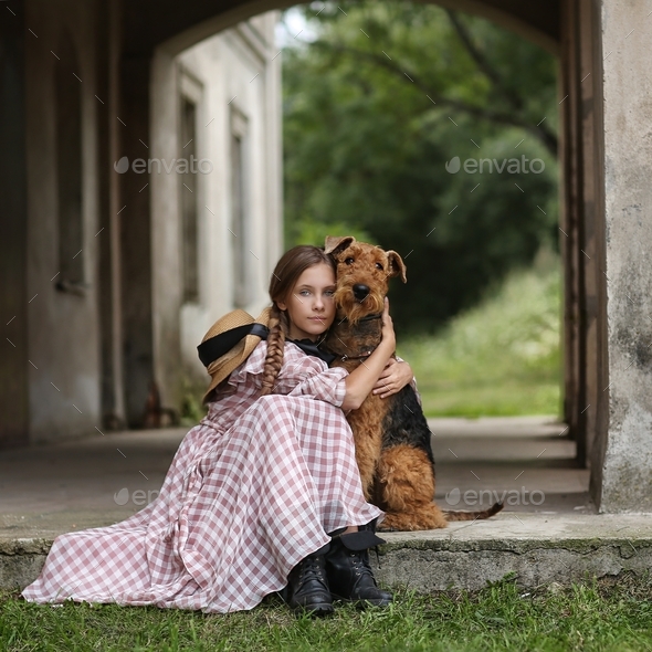 beautiful teenage girl hugging a dog breed elder terrier