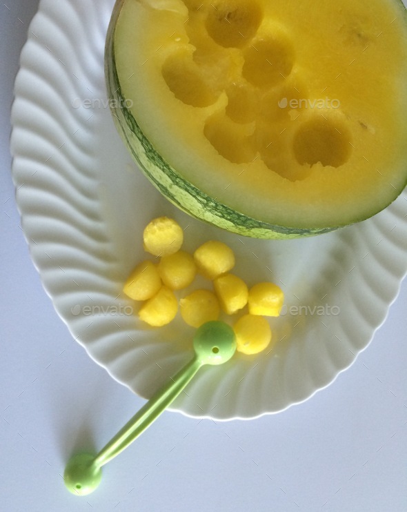 Fresh healthy eating overhead of yellow watermelon being cut using a
