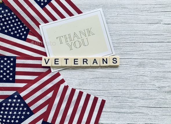 Thank you Veterans patriotic Flat lay with USA flags a thank you note & veterans In tile letters