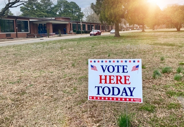“Vote here today” sign at the entrance of a polling site.