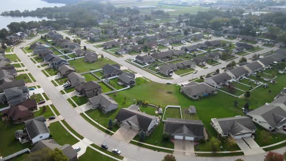 Aerial view of newer residential neighborhood in western Wisconsin. Lake and trees in background.