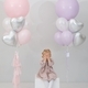 Blonde girl hides her face in her hands with pink and silver heart-shaped balloons in the studio. - PhotoDune Item for Sale