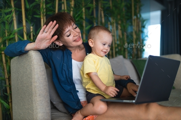 Working mom. Work from home. A mother works with her child. Video conference. Mom and her son.