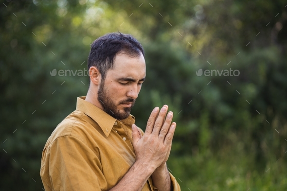 The man prays to God. Prayer time. Prayer and worship of God. Spirituality.