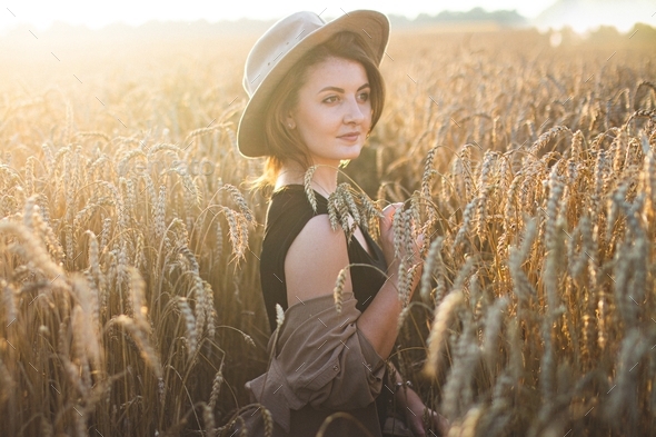 Photo shoot of a girl in the field. Natural beauty. Rest and relaxation. Open area. Sunset.