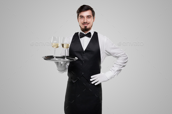 Positive waiter serving wine on tray