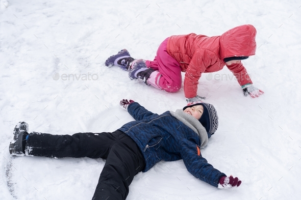 Little children playing with snow. Winter holiday Stock Photo by Nastyaofly