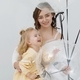 Woman with blonde daughter in white studio with balloons. - PhotoDune Item for Sale