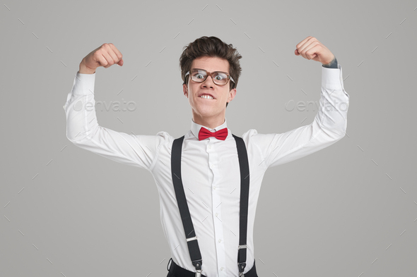 Funny nerd in formal outfit showing muscles
