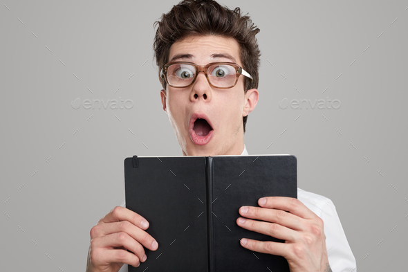 Shocked funny student with book