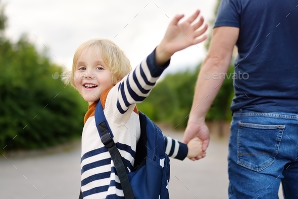 Little boy with his father going to school after summer break
