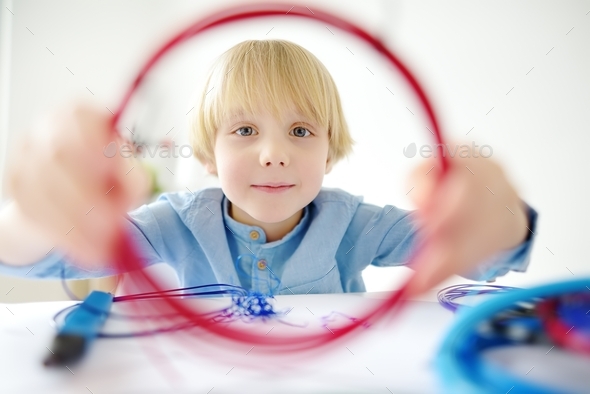 Little boy learning make model with 3d printing pen. Child playing with ...