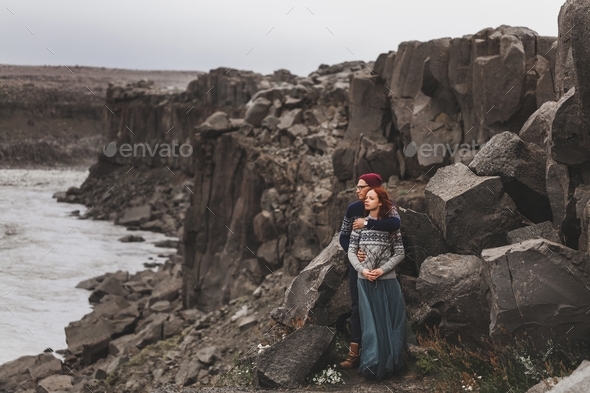 Couple in love walking in Iceland. View of Jokulsa a Fjollum river canyon in cold and gray autumn