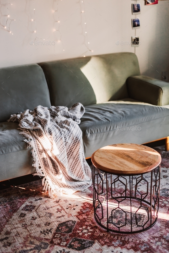 Home interior decoration. Living room. Couch and coffee table. Morning light. Authentic rug. Cozy