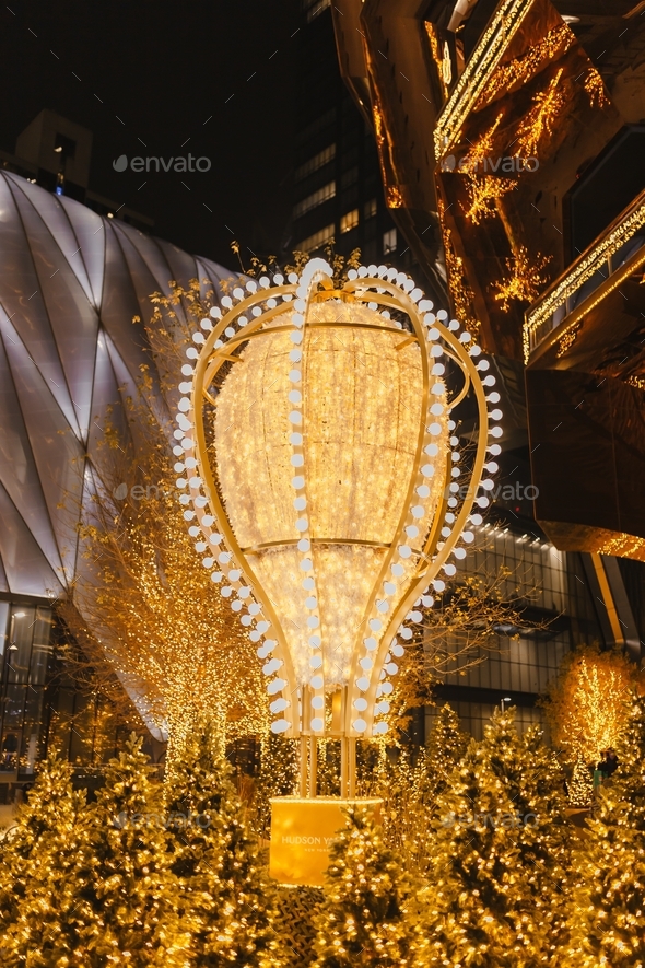 Enchanting Christmas moment. Hudson Yards Christmas lights. Illuminated golden air balloon.