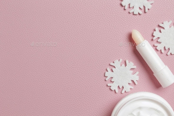 Set of cosmetic products on pink background, flat lay. Winter care