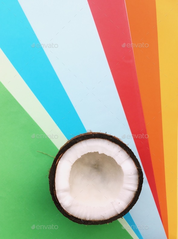 half a coconut on a colorful background Stock Photo by margaritaylita