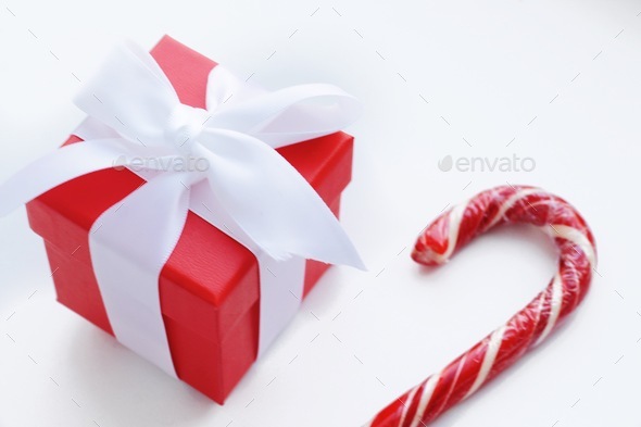 Gift box and candy cane Stock Photo by margaritaylita | PhotoDune