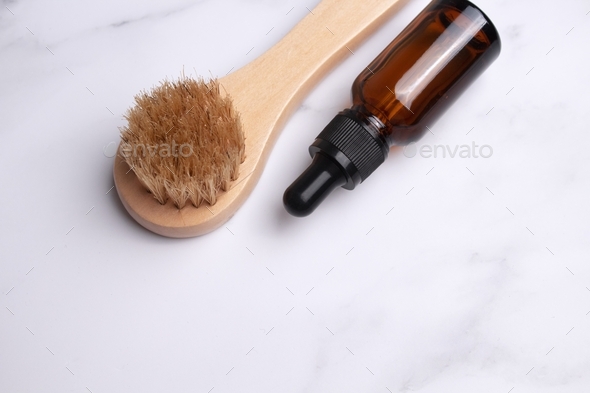 Set of home SPA cosmetic products. Dry Brush, Organic Oil. Anti-cellulite brush for dry body massage