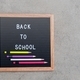 Flat lay of blackboard with wooden frame with message says Back To School decorated with pencils - PhotoDune Item for Sale