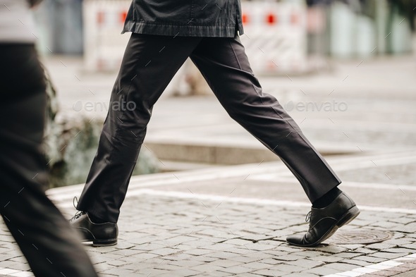 Businessmen in hurry to reach office in formal black clothes in the day