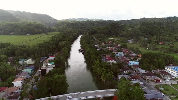 Aerial view of river crossing the city of Loboc, Philippines. alt