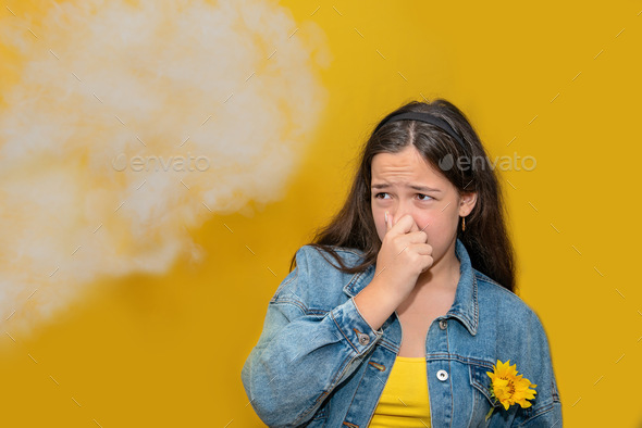 Passive smoking concept. Teen girl pinch her nose because toxic fumes from car,bad smell