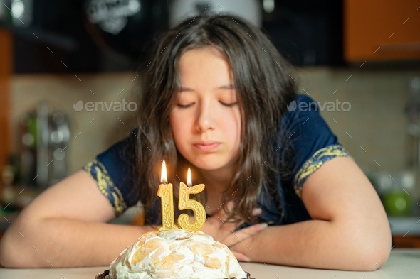 the girl makes a wish and blows out the candles on the cake
