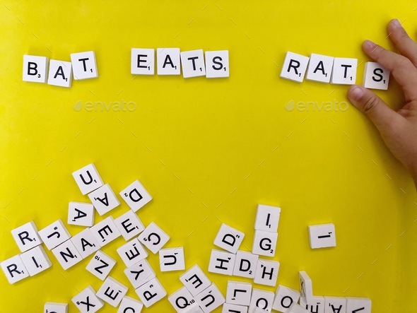 Kid learning to read using Scrabble
