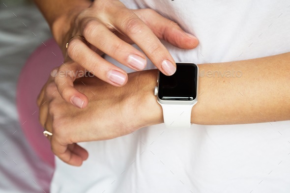 Closeup photo of Woman hands with manicure using smart apple watches  - Stock Photo - Images