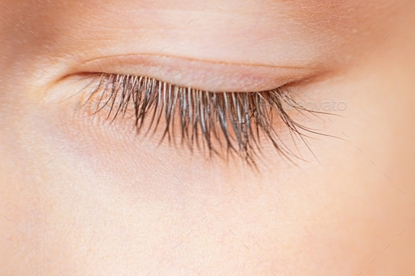 Closeup macro photo of closed eye with long natural eyelashes