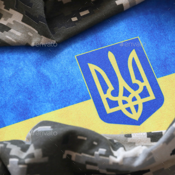 Ukrainian flag and coat of arms with fabric with texture of pixeled camouflage - Stock Photo - Images