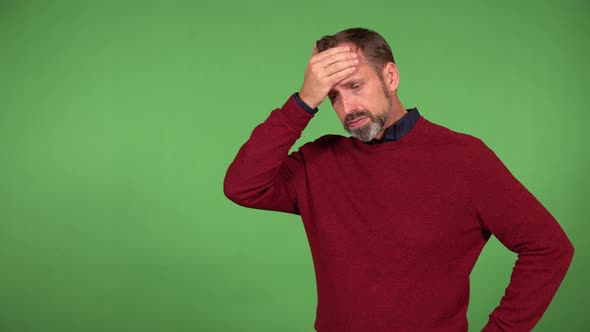 A Middleaged Handsome Caucasian Man Has a Headache  Green Screen Background