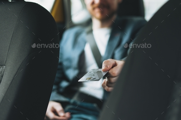 Business man pays by credit card in taxi