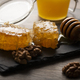 Honeycomb on slate tray with honey and nuts on kitchen table - PhotoDune Item for Sale