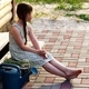 A little village girl is sitting on the porch - PhotoDune Item for Sale