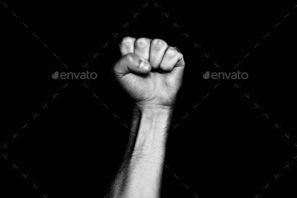 Male hand clenched into a fist. The black life of matter. The protest against racism.