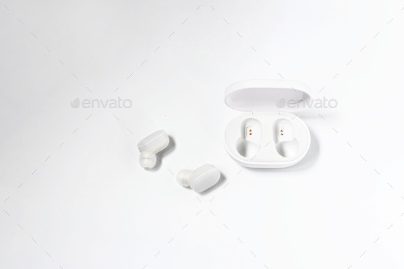 Wireless headphones and charger on a white background