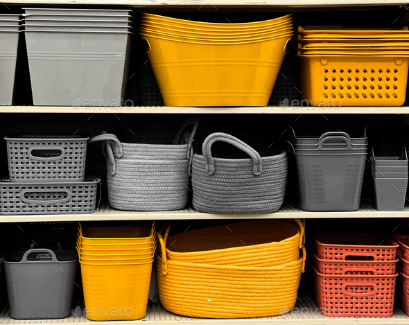 Different colored storage bins on shelves - Stock Photo - Images